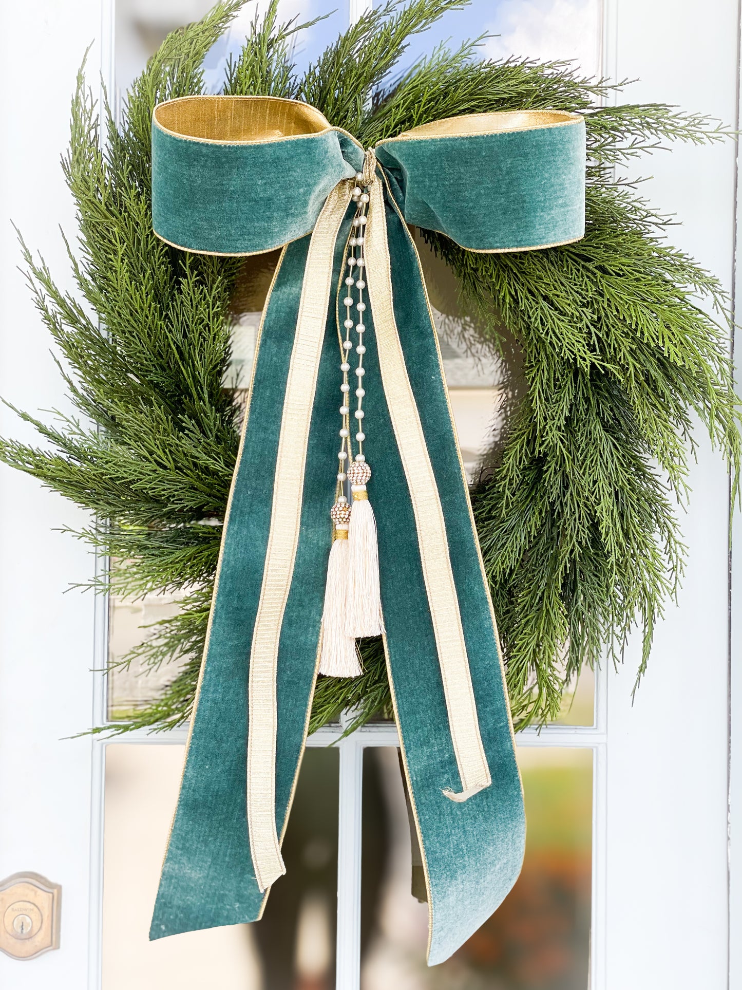 The Celadon Noel Cedar Wreath And Bow With Pearl Tassel.