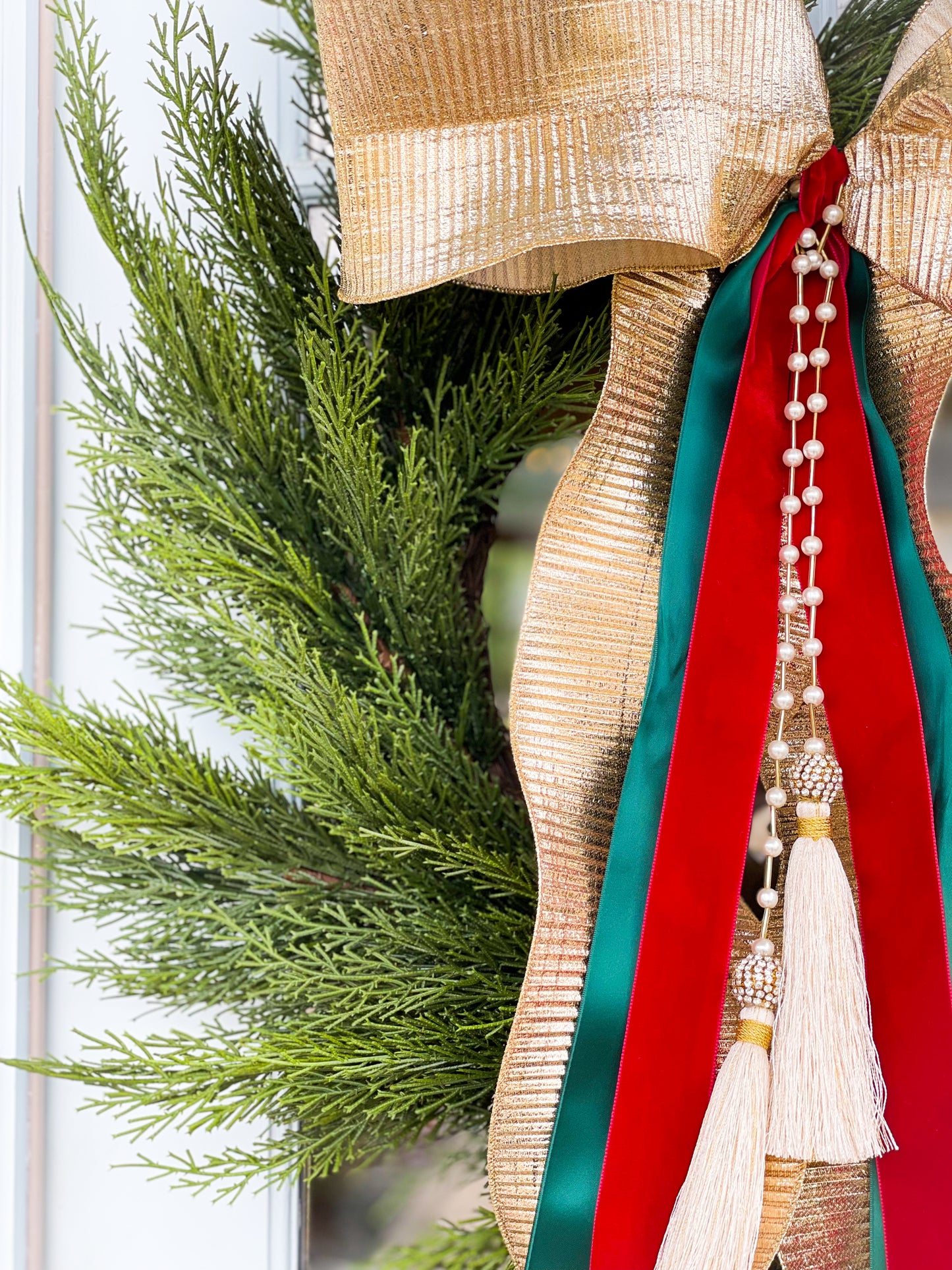 The Gold Noel Cedar Wreath And Bow With Pearl Tassel.