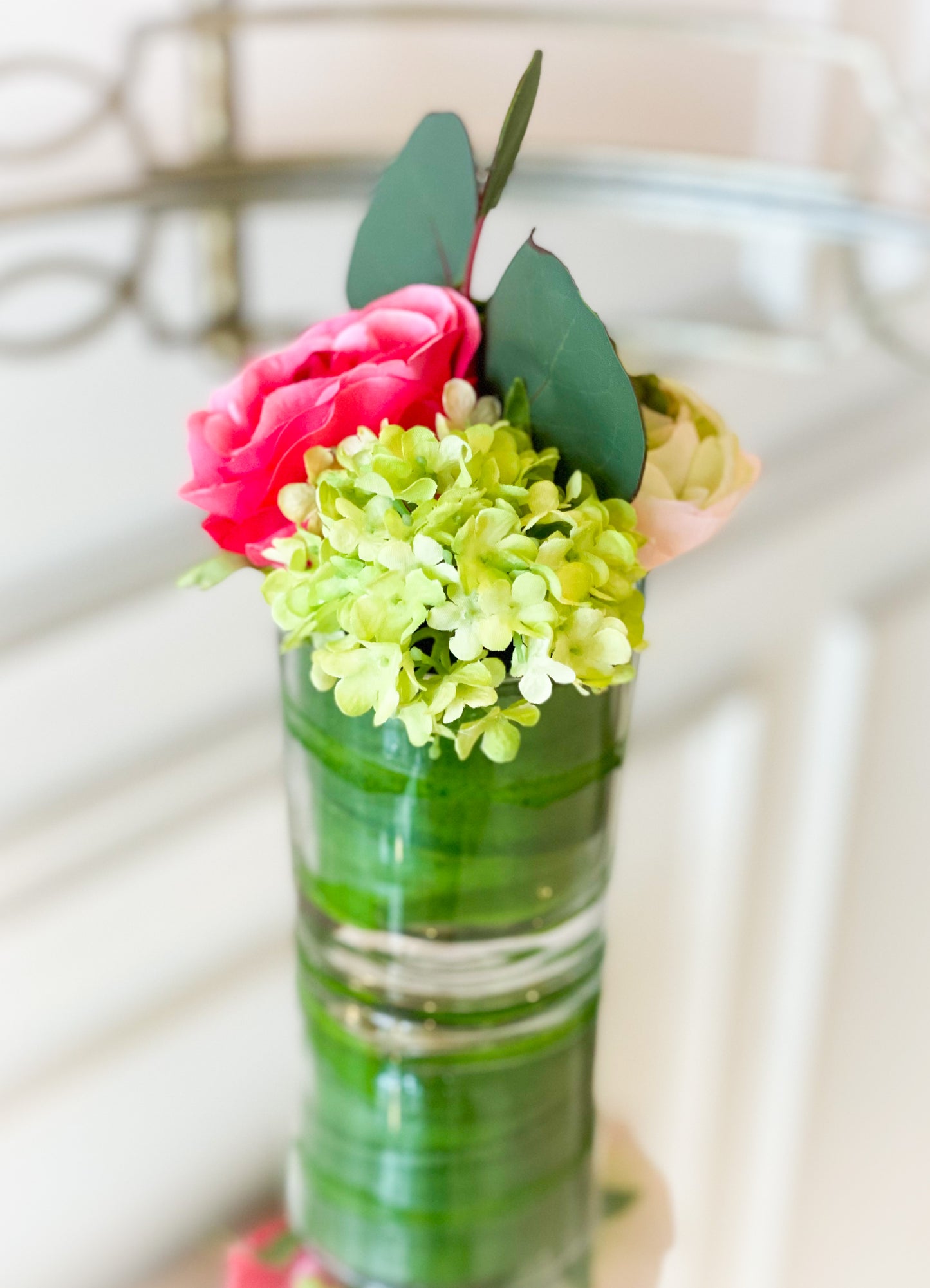 Ranunculus, Rose, And Snowball In A Glass Vase